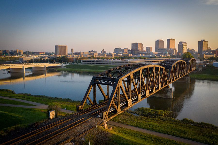 About Our Agency - View of Bridge Across the River and Surrounding View of Dayton Ohio at Sunset